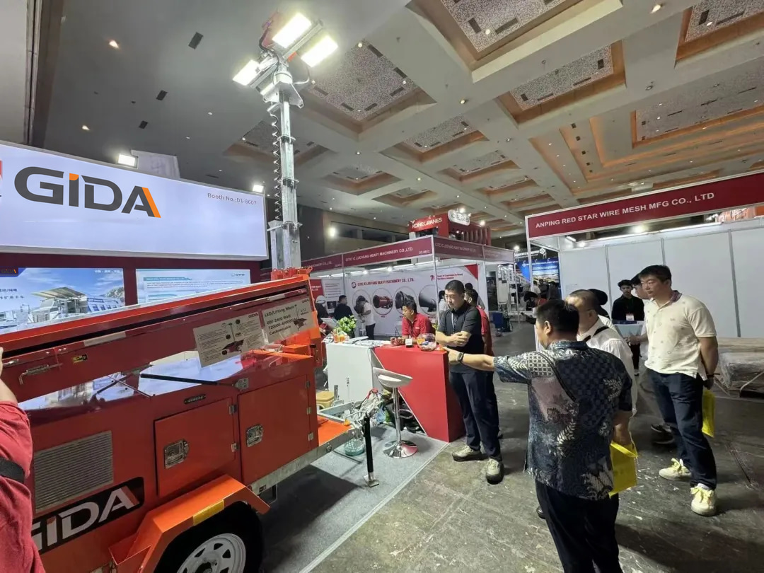 GIDA team demonstrating the orange mobile lighting tower